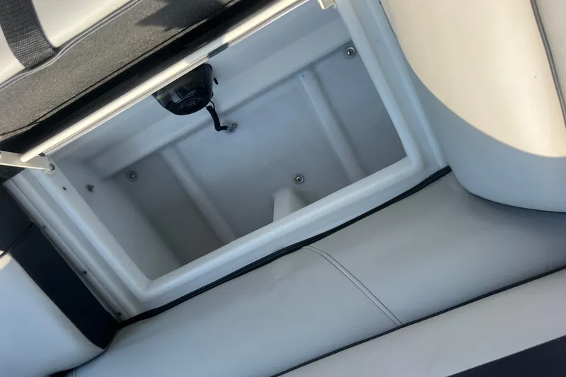Slide: The Image of Open storage compartment in 2022 Viaggio Lago V-U 22 boat, featuring sleek white interior design. - 29