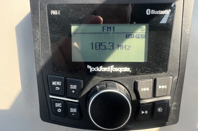 Slide: The Image of Rockford Fosgate PMX-1 stereo displaying FM radio at 105.3 MHz, Bluetooth enabled. - 26