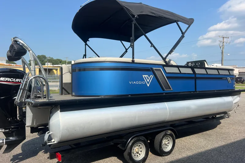 Slide: The Image of 2022 Viaggio Lago V-U 22 pontoon boat with blue exterior and black canopy. - 11