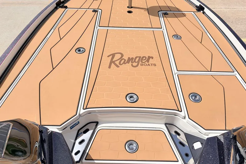 Slide: The Image of 2026 Ranger Z521R Ultra boat deck with tan non-slip surface and logo. - 21