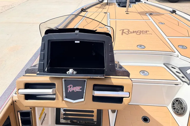 Slide: The Image of 2026 Ranger Z521R Ultra boat interior with tan deck and storage compartments. - 36