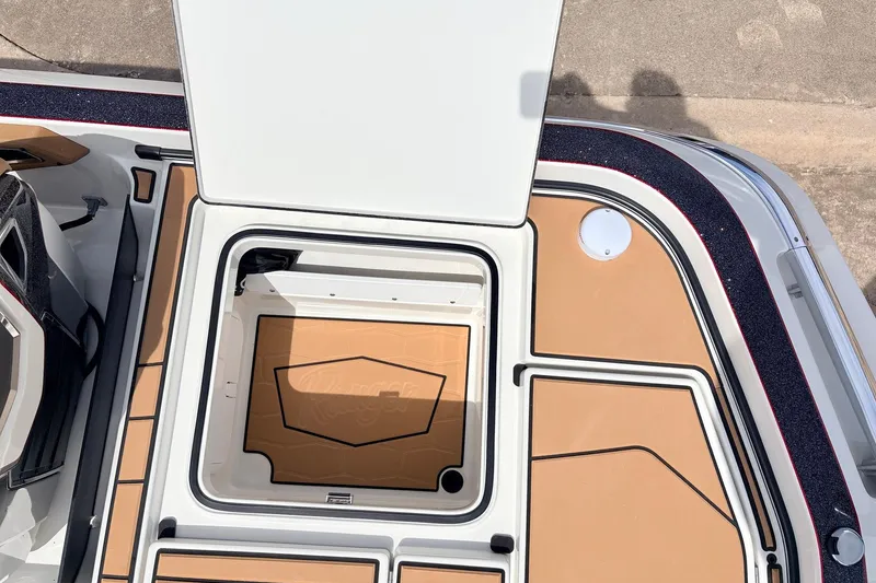 Slide: The Image of 2026 Ranger Z521R Ultra boat storage compartment with open lid, showcasing spacious interior design. - 57