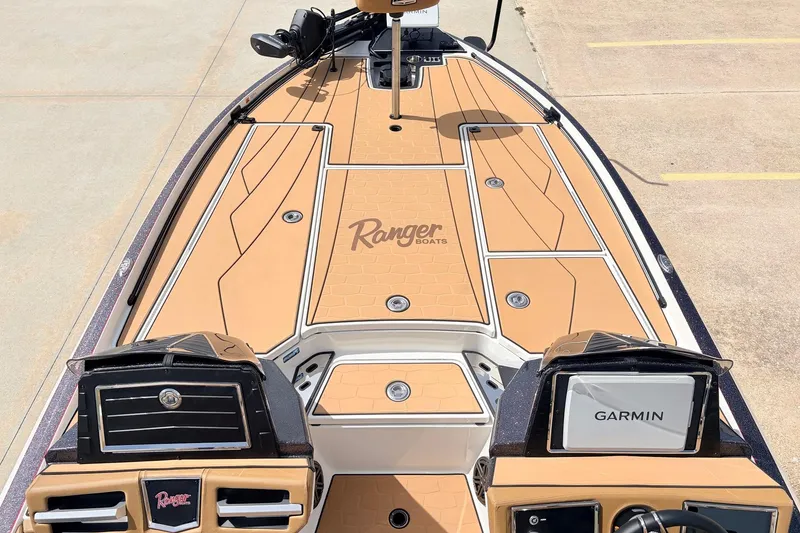 Slide: The Image of 2026 Ranger Z521R Ultra boat deck with Garmin system, featuring tan and black design. - 13