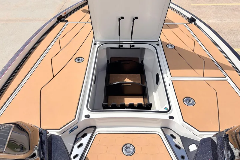 Slide: The Image of 2026 Ranger Z521R Ultra boat deck with open storage compartment, showcasing sleek design and functionality. - 22