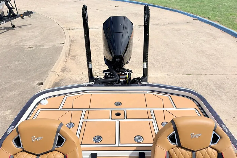 Slide: The Image of 2026 Ranger Z521R Ultra boat with tan seats and sleek motor design. - 48