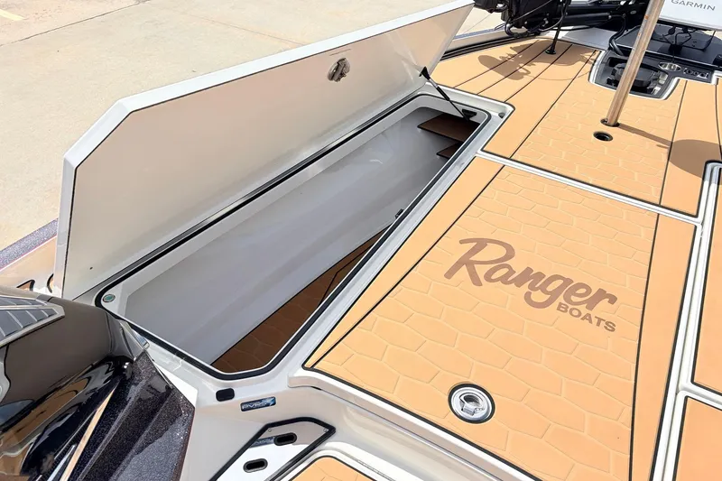 Slide: The Image of 2026 Ranger Z521R Ultra boat deck with open storage compartment and logo. - 19