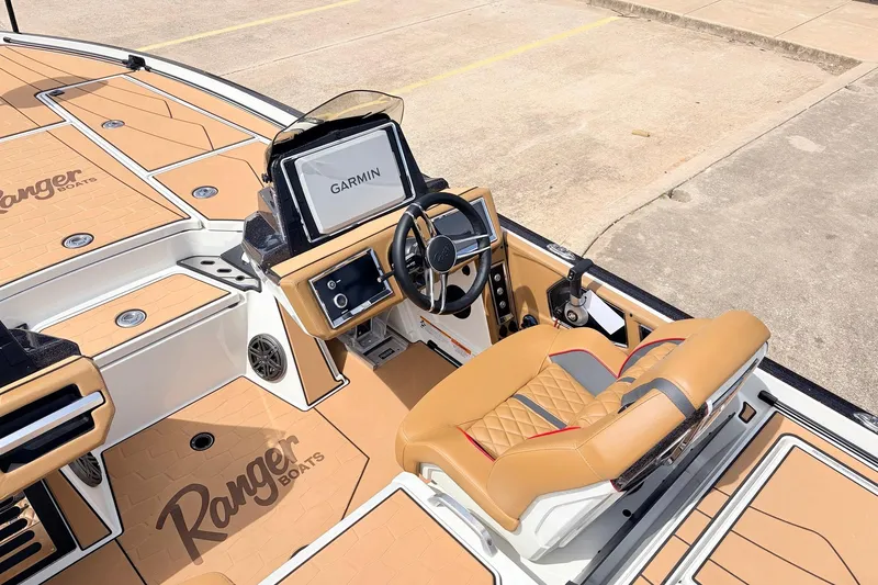 Slide: The Image of 2026 Ranger Z521R Ultra boat interior with Garmin navigation system and tan seating. - 38