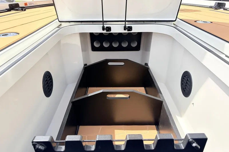 Slide: The Image of 2026 Ranger Z521R Ultra boat storage compartment with organized dividers and ventilation. - 23