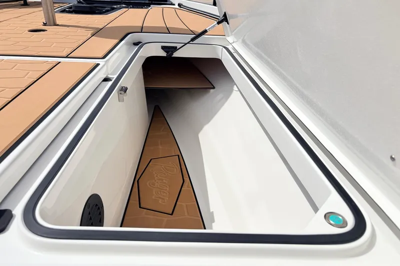 Slide: The Image of Open storage compartment on 2026 Ranger Z521R Ultra boat, featuring sleek design and ample space. - 26