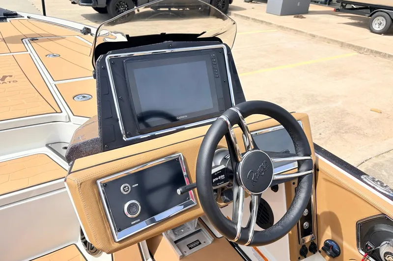 Slide: The Image of 2026 Ranger Z521R Ultra boat dashboard with steering wheel and navigation display. - 39