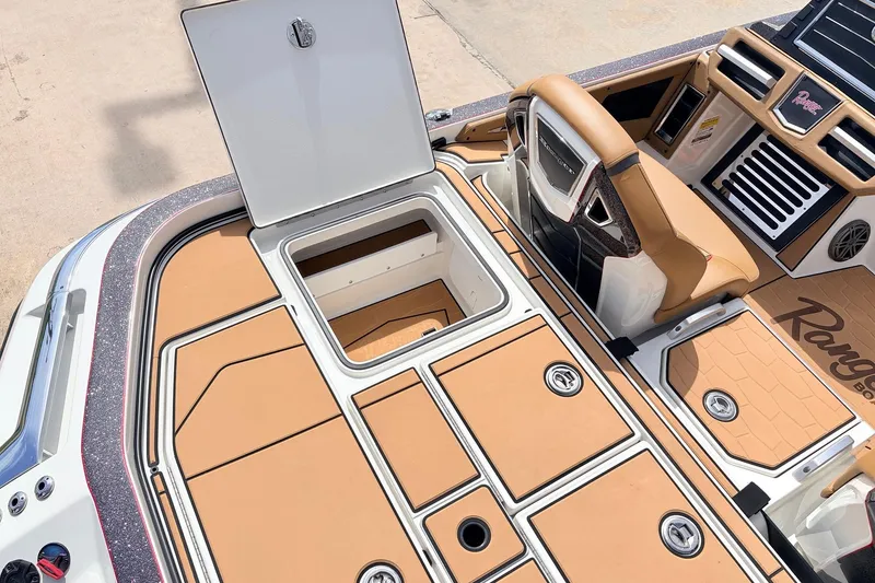 Slide: The Image of 2026 Ranger Z521R Ultra boat interior with open storage compartment and tan seating. - 53