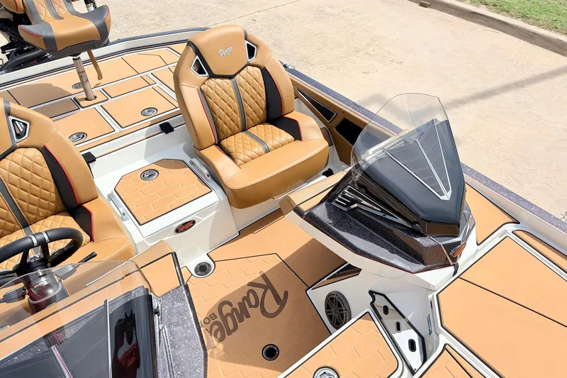 Slide: The Image of 2026 Ranger Z521R Ultra boat interior with tan leather seats and sleek dashboard design. - 34