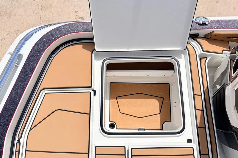 Slide: The Image of 2026 Ranger Z521R Ultra boat storage compartment with open lid, showcasing sleek design and spacious interior. - 54