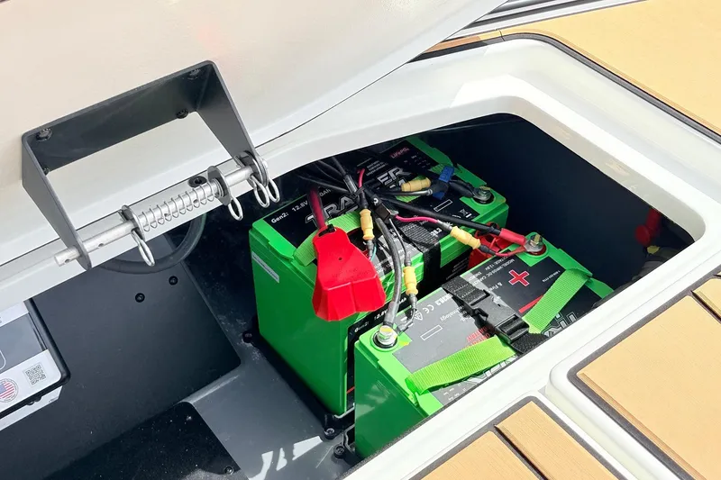 Slide: The Image of Battery compartment of 2026 Ranger Z521R Ultra boat, featuring green batteries and wiring. - 60
