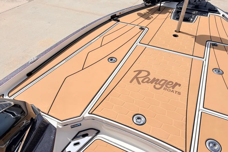 Slide: The Image of 2026 Ranger Z521R Ultra boat deck with tan non-slip surface and logo. - 18