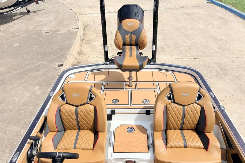 Slide: The Image of 2026 Ranger Z521R Ultra boat with luxurious tan and black seating on a sleek deck. - 44