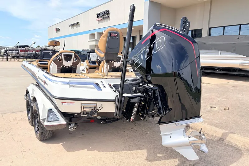Slide: The Image of 2026 Ranger Z521R Ultra boat with powerful engine, parked outside dealership. - 11