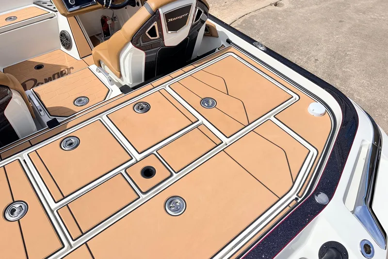 Slide: The Image of 2026 Ranger Z521R Ultra boat deck with tan and white detailing, featuring storage compartments. - 55