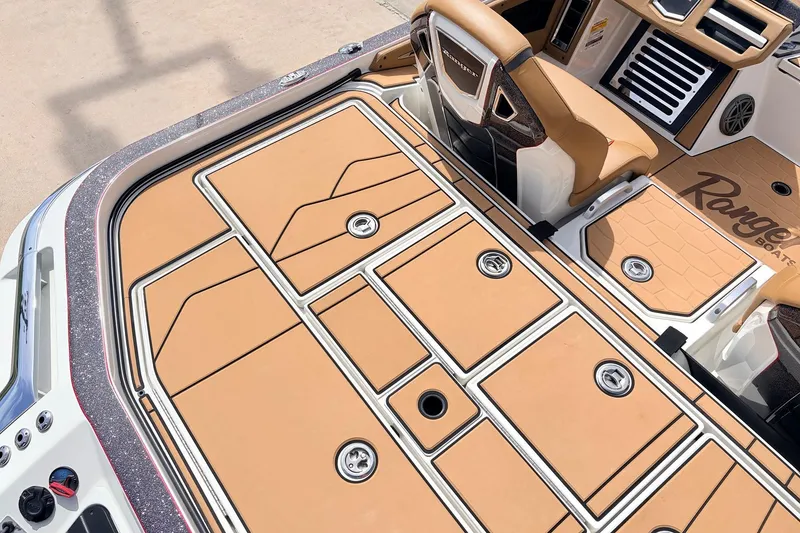 Slide: The Image of 2026 Ranger Z521R Ultra boat deck with tan and white design, featuring storage compartments. - 52