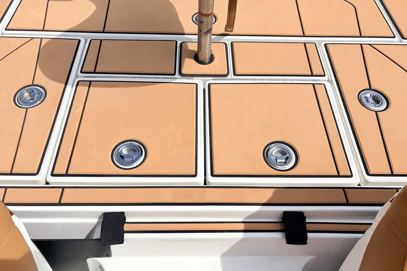 Slide: The Image of 2026 Ranger Z521R Ultra boat deck with tan panels and metal fixtures. - 47