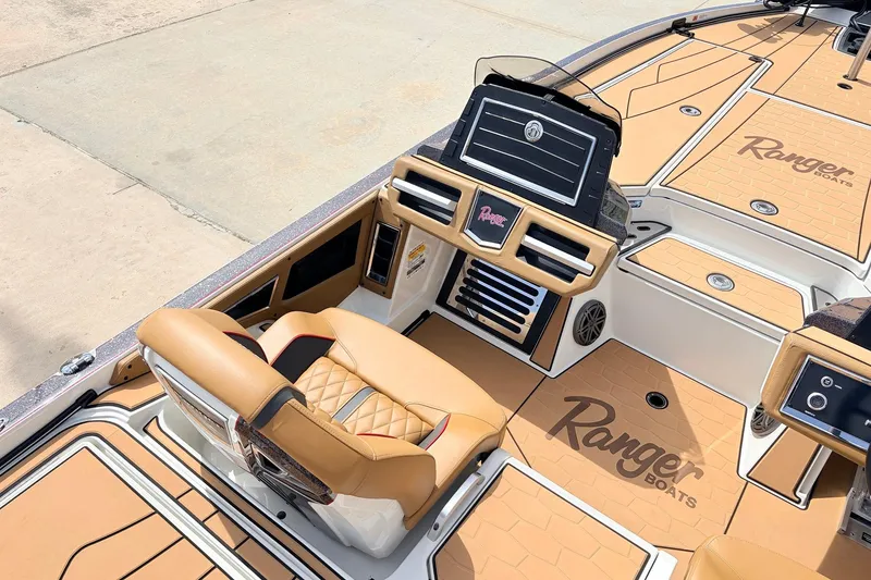 Slide: The Image of 2026 Ranger Z521R Ultra boat interior with tan seating and advanced dashboard. - 35