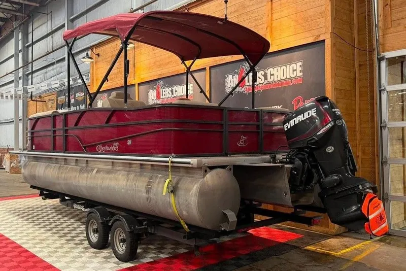 Slide: The Image of 2020 Misty Harbor 2285RSF pontoon boat with Evinrude motor in showroom. - 2