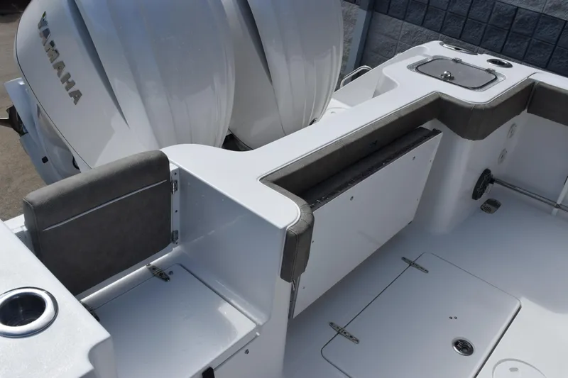 Slide: The Image of 2027 Sea Hunt Gamefish 28 boat interior with Yamaha engines, featuring seating and storage. - 7