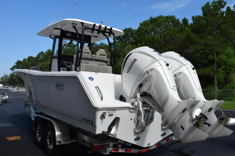Slide: The Image of 2027 Sea Hunt Gamefish 28 boat with dual Yamaha engines on a trailer. - 6
