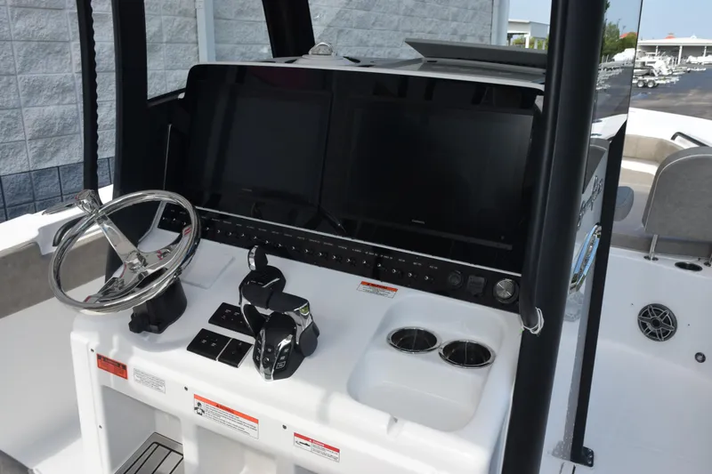 Slide: The Image of 2027 Sea Hunt Gamefish 28 helm with dual screens and modern controls. - 9