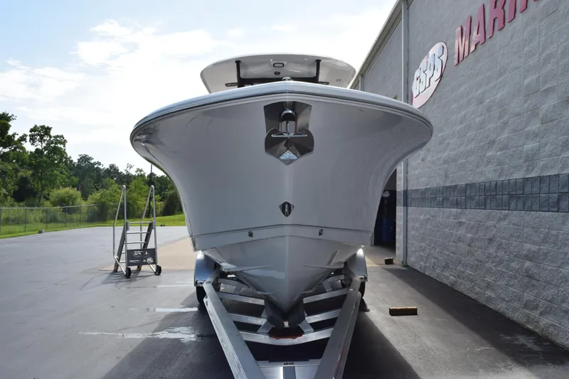 Slide: The Image of 2027 Sea Hunt Gamefish 28 Forward Seating boat on trailer outside marine shop. - 3
