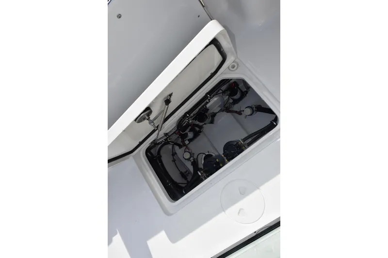 Slide: The Image of Open hatch of 2027 Sea Hunt Gamefish 28, revealing internal components and wiring. - 23
