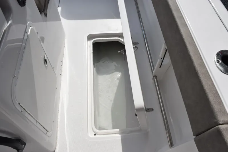 Slide: The Image of 2027 Sea Hunt Gamefish 28 Forward Seating boat interior with open storage compartment. - 16