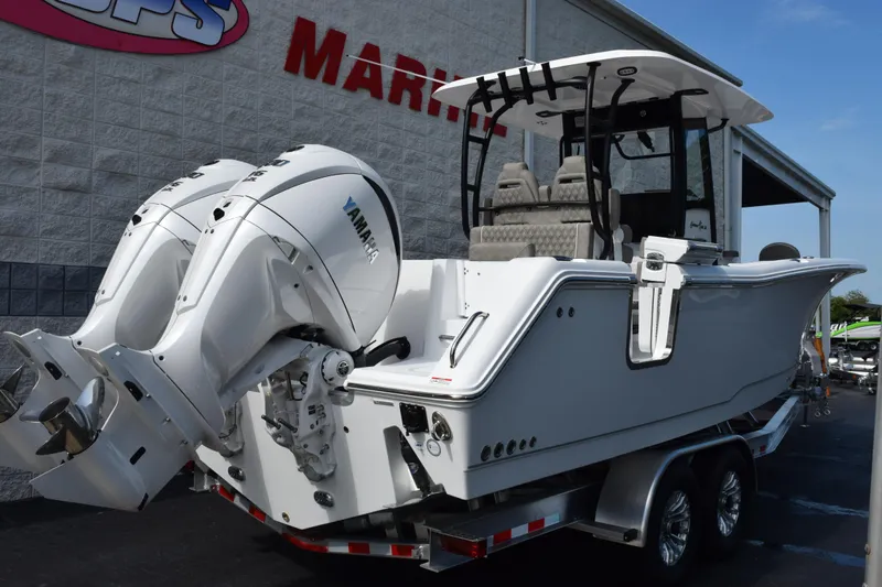 Slide: The Image of 2027 Sea Hunt Gamefish 28 boat with dual Yamaha engines on a trailer. - 4