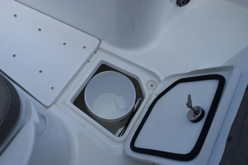 Slide: The Image of 2027 Sea Hunt Gamefish 28 boat storage compartment with bucket and latch. - 19