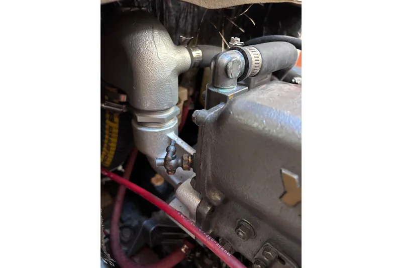 Slide: The Image of Close-up of a 1989 CAL 33 engine component with hoses and metal fittings. - 25