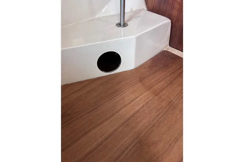 Slide: The Image of Wooden boat interior with white fiberglass structure, CAL 33 model, 1989. - 33