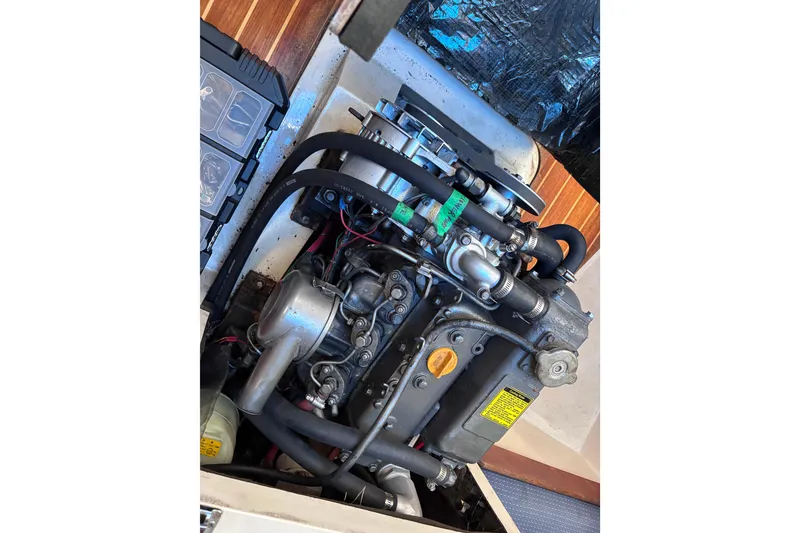 Slide: The Image of Engine compartment of a 1989 CAL 33 sailboat, showcasing detailed mechanical components. - 28