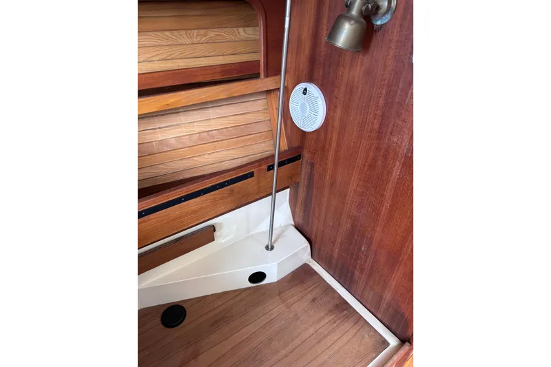 Slide: The Image of Interior of 1989 CAL 33 sailboat with wooden paneling and nautical decor. - 32