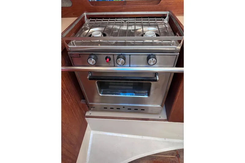 Slide: The Image of Stainless steel stove and oven in a 1989 CAL 33 sailboat galley. - 14
