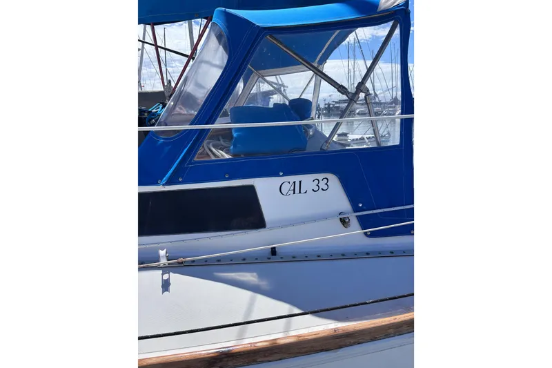 Slide: The Image of Blue and white CAL 33 sailboat from 1989 docked at a marina. - 5
