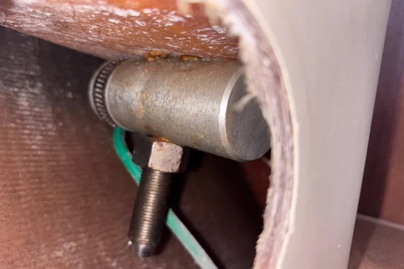 Slide: The Image of Close-up of a metal component inside a 1989 CAL 33 boat. - 34