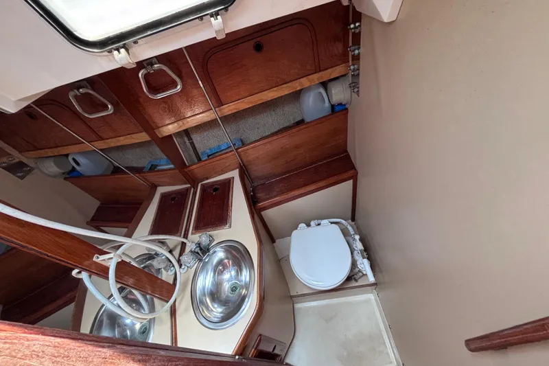 Slide: The Image of Compact bathroom in a 1989 CAL 33 sailboat with sink and toilet. - 21