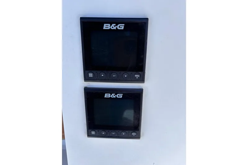 Slide: The Image of B&G marine displays on a 1989 CAL 33 sailboat, featuring navigation controls. - 37