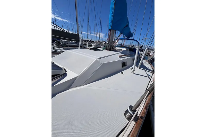 Slide: The Image of 1989 CAL 33 sailboat deck with blue sail cover, docked in marina. - 3