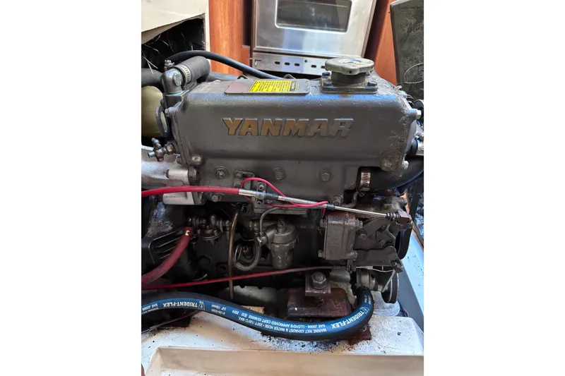 Slide: The Image of Yanmar engine in a 1989 CAL 33 sailboat, showcasing detailed mechanical components. - 24