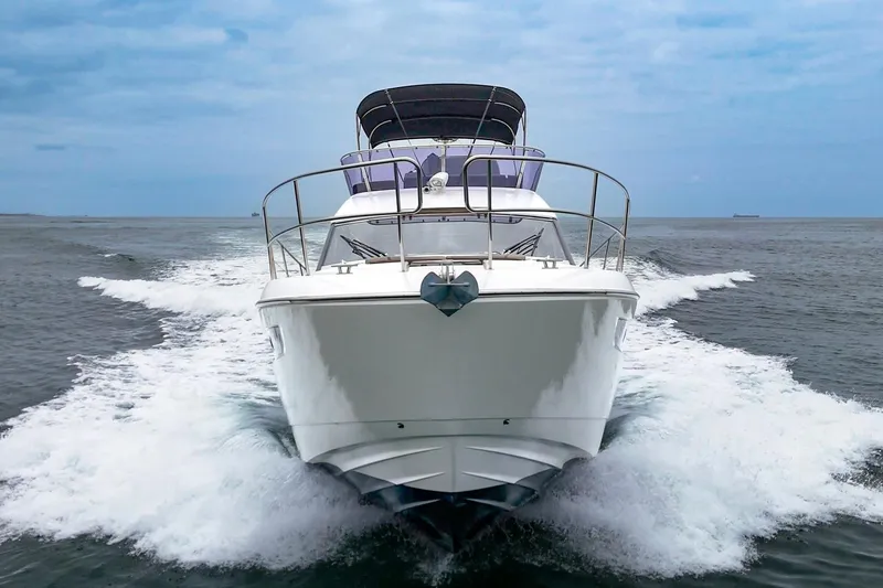 Slide: The Image of 2017 Bavaria R40 Fly yacht cruising on open water, front view. - 7