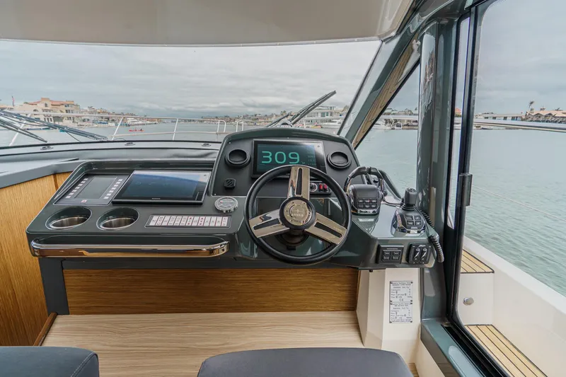 Slide: The Image of Helm of 2017 Bavaria R40 Fly yacht with modern controls and waterfront view. - 42