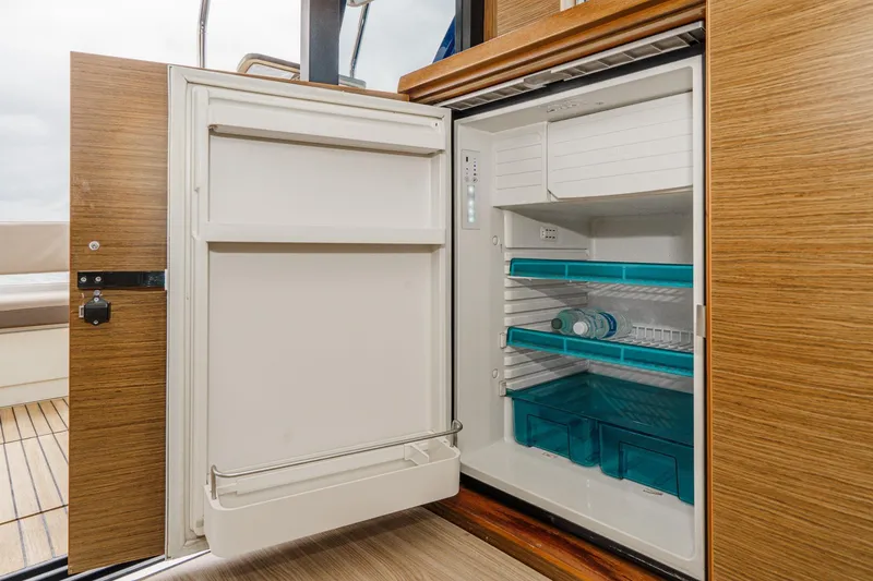 Slide: The Image of Open refrigerator on Bavaria R40 Fly yacht, showcasing spacious interior and modern design. - 30