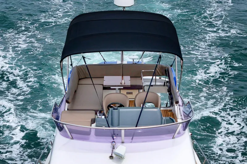 Slide: The Image of 2017 Bavaria R40 Fly yacht cruising on open water, featuring a spacious flybridge. - 17