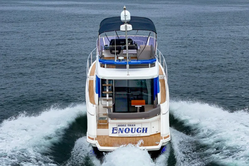 Slide: The Image of Bavaria R40 Fly 2017 yacht cruising on open water, rear view. - 18